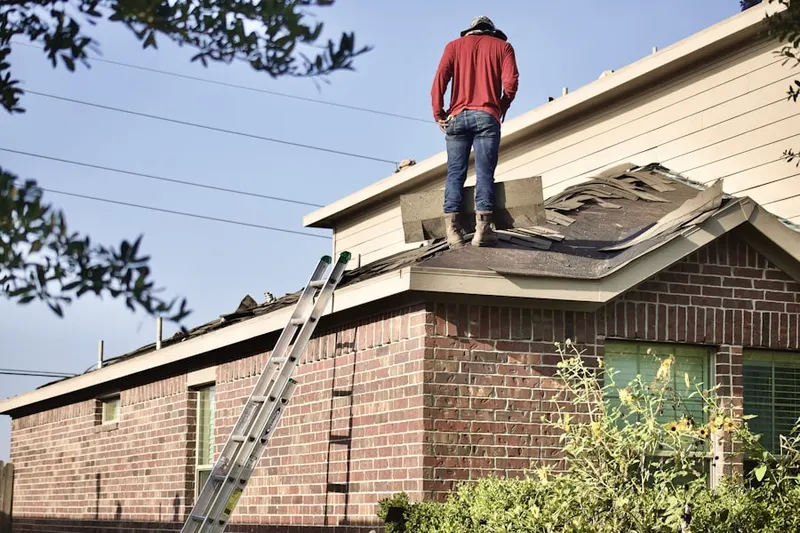 Professional roofer working on a residential roof in Broadview